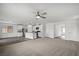 Spacious living room with modern ceiling fan flows into a kitchen with stainless appliances and large island at 1704 Desert Path Ave, North Las Vegas, NV 89032