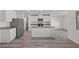 Modern kitchen featuring white cabinets, stainless steel appliances, and a center island with bar seating at 1717 Desert Path Ave, North Las Vegas, NV 89032