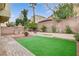 Inviting backyard boasts artificial turf, a water feature, lovely landscaping, and a serene, private setting at 2033 Shining Feather Ln, Las Vegas, NV 89134