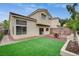 This backyard features artificial turf, patio space, and lush planter beds, perfect for relaxing and entertaining at 2033 Shining Feather Ln, Las Vegas, NV 89134