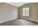 Light-filled bedroom with wood-look floors and neutral color palette at 2033 Shining Feather Ln, Las Vegas, NV 89134
