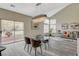 Dining area with sliding glass doors to outdoor space, modern chandelier, and comfortable seating at 2033 Shining Feather Ln, Las Vegas, NV 89134