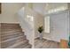 Inviting entryway featuring wood stairs, a front door, and neutral paint colors at 2033 Shining Feather Ln, Las Vegas, NV 89134