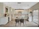 Bright kitchen features white cabinets, stainless steel appliances, a large island, and an elegant chandelier at 2033 Shining Feather Ln, Las Vegas, NV 89134