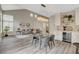 Open living and dining area with chandelier lighting, stylish furniture, and ample natural light at 2033 Shining Feather Ln, Las Vegas, NV 89134