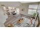 Open-concept space featuring kitchen, dining, and living room with wood-look flooring and natural light at 2033 Shining Feather Ln, Las Vegas, NV 89134