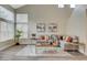 Inviting living room featuring a large window, a comfortable sectional sofa with stylish accents, and modern decor at 2033 Shining Feather Ln, Las Vegas, NV 89134