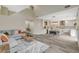 Open-concept living space features a comfortable sofa and a gourmet kitchen complete with an island and modern appliances at 2033 Shining Feather Ln, Las Vegas, NV 89134