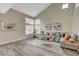 Warm and inviting living room showcasing a large window, stylish sectional sofa, and chic decor for comfortable living at 2033 Shining Feather Ln, Las Vegas, NV 89134