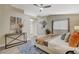Spacious main bedroom features ensuite bath, ceiling fan, and wood-look flooring at 2033 Shining Feather Ln, Las Vegas, NV 89134