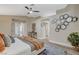 Comfortable main bedroom features vaulted ceiling, ensuite bath, and wood-look flooring at 2033 Shining Feather Ln, Las Vegas, NV 89134