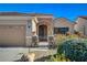 Inviting single-story home featuring a stone accent archway and lush landscaping at 2142 Oliver Springs St, Henderson, NV 89052