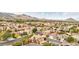 Scenic aerial shot of a neighborhood showcasing uniform housing, mature trees, and mountain backdrop at 2337 Ivory Point Ct, Las Vegas, NV 89134