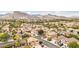 Elevated view of a suburban neighborhood featuring tile roofs, green trees and manicured lawns at 2337 Ivory Point Ct, Las Vegas, NV 89134