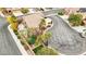 Aerial view showcases a meticulously maintained backyard with a putting green, refreshing pool and lush landscaping at 2337 Ivory Point Ct, Las Vegas, NV 89134