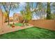 Green backyard featuring desert foliage and a stucco exterior elevation at 2337 Ivory Point Ct, Las Vegas, NV 89134
