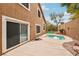 View of the backyard patio featuring a small pool and adjacent backyard wall at 2337 Ivory Point Ct, Las Vegas, NV 89134