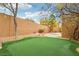 Green backyard featuring a putting green, desert landscaping and exterior fence at 2337 Ivory Point Ct, Las Vegas, NV 89134