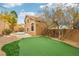 Backyard with putting green, foliage, mature trees, and exterior elevation view at 2337 Ivory Point Ct, Las Vegas, NV 89134