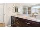 Bathroom vanity with double sinks, granite countertop, dark cabinets, and large mirrors at 2337 Ivory Point Ct, Las Vegas, NV 89134