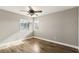 A bright bedroom with hardwood floors, two windows, and a ceiling fan at 2337 Ivory Point Ct, Las Vegas, NV 89134