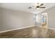 Primary bedroom featuring hardwood floors, ceiling fan, and ensuite bathroom with tub and glass shower at 2337 Ivory Point Ct, Las Vegas, NV 89134