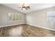 Spacious bedroom with hardwood floors, ceiling fan, and a bright window at 2337 Ivory Point Ct, Las Vegas, NV 89134