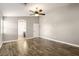 Bedroom with hardwood floors, ceiling fan, and doorway to a bathroom at 2337 Ivory Point Ct, Las Vegas, NV 89134