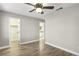 A bright bedroom with hardwood floors and views into the bathroom and closet at 2337 Ivory Point Ct, Las Vegas, NV 89134