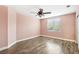 A charming bedroom featuring hardwood floors and a ceiling fan at 2337 Ivory Point Ct, Las Vegas, NV 89134
