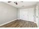 A cozy bedroom with hardwood floors, closet doors, and a ceiling fan at 2337 Ivory Point Ct, Las Vegas, NV 89134