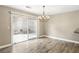 Dining room with chandelier and sliding glass doors to a patio with chairs and gravel at 2337 Ivory Point Ct, Las Vegas, NV 89134