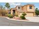 Stucco home with a three-car garage, front lawn, and desert landscaping at 2337 Ivory Point Ct, Las Vegas, NV 89134