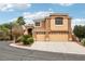 Two-story stucco home featuring a three-car garage and well-maintained landscaping at 2337 Ivory Point Ct, Las Vegas, NV 89134