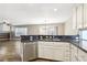Open kitchen featuring stainless steel appliances, dark countertops, and hardwood flooring at 2337 Ivory Point Ct, Las Vegas, NV 89134