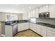Well-appointed kitchen features granite counters, white cabinetry, and stainless appliances at 2337 Ivory Point Ct, Las Vegas, NV 89134
