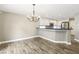 Inviting kitchen and dining area feature sleek wood floors and modern chandelier at 2337 Ivory Point Ct, Las Vegas, NV 89134