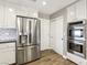 Stainless steel refrigerator and double ovens with white cabinets and subway tile backsplash at 2337 Ivory Point Ct, Las Vegas, NV 89134