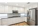 Bright kitchen with white cabinets, stainless appliances, dark countertops, and subway tile backsplash at 2337 Ivory Point Ct, Las Vegas, NV 89134