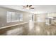 Bright living room featuring modern ceiling fan, beautiful floors, and sliding glass doors at 2337 Ivory Point Ct, Las Vegas, NV 89134