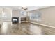 Open living area offers fireplace, shelving, large window, and wood-look floors at 2337 Ivory Point Ct, Las Vegas, NV 89134