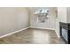 Living room with wood floors, large window, chandelier, and fireplace at 2337 Ivory Point Ct, Las Vegas, NV 89134