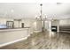 Inviting living space with sleek floors, fireplace, and adjacent kitchen with stainless appliances at 2337 Ivory Point Ct, Las Vegas, NV 89134