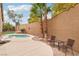 Backyard patio space with outdoor furniture, a small pool, and palm trees at 2337 Ivory Point Ct, Las Vegas, NV 89134