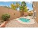 A private backyard oasis with a pool, brick patio, and lush landscaping at 2337 Ivory Point Ct, Las Vegas, NV 89134