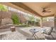 Charming backyard patio with shade, a fountain feature, mature landscaping, and comfortable seating at 2413 Hamonah Dr, Henderson, NV 89044