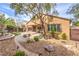 Expansive backyard with a patio, fountain, lush trees, and well-maintained landscaping at 2413 Hamonah Dr, Henderson, NV 89044