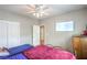 Cozy bedroom featuring a ceiling fan, TV, and closet, perfect for relaxation and organization at 2413 Hamonah Dr, Henderson, NV 89044