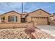 Attractive home with a two-car garage, xeriscaping, and welcoming curb appeal at 2413 Hamonah Dr, Henderson, NV 89044