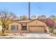 Charming single-story home with well-manicured landscaping and a two-car garage at 2413 Hamonah Dr, Henderson, NV 89044